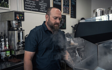 Male Veteran Working Espresso Machine in Coffee Shop 