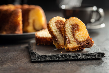 Sweet sponge cake. Bundt cake on dark table.