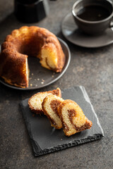 Sweet sponge cake. Bundt cake on dark table.