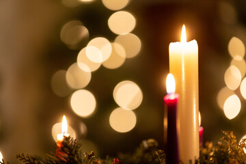 Christmas candles in dark with glowing lights