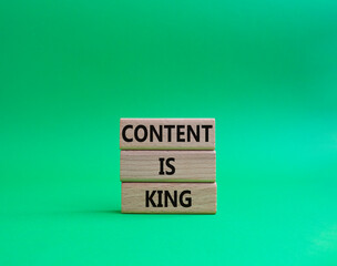 Content is king symbol. Concept words Content is king on wooden blocks. Beautiful green background. Business and Content is king concept. Copy space.