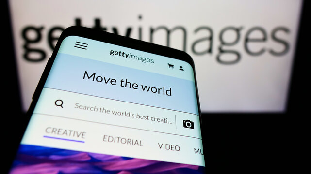 Stuttgart, Germany - 12-12-2021: Smartphone with website of stock photo provider Getty Images Inc. on screen in front of company logo. Focus on top-left of phone display.