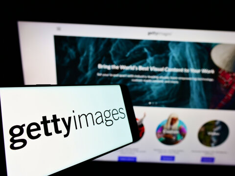 Stuttgart, Germany - 12-12-2021: Mobile phone with logo of stock photo provider Getty Images Inc. on screen in front of company website. Focus on center-left of phone display.