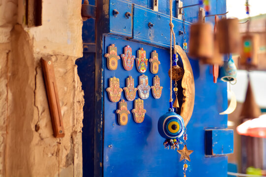 Colorful vintage item hamsa
   of a light blue door in the old city of Safed. In Israel in a spectacular antique store