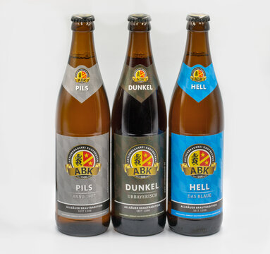 German ABK Pils, Dunkel and Hell bottles closeup on white.
