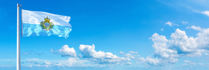 Obraz na płótnie Canvas San Marino flag on a blue sky *** Horizontal banner 12000 x 4005 px