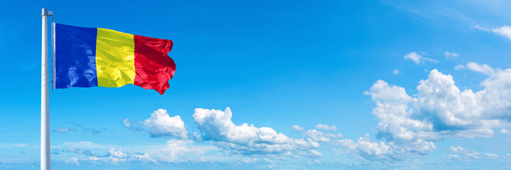 Romania flag on a blue sky *** Horizontal banner 12000 x 4005 px