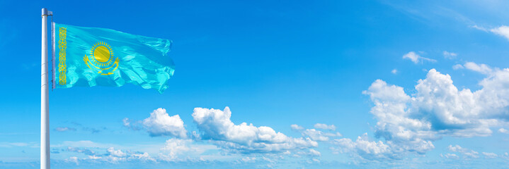 Fototapeta na wymiar Kazakhstan flag on a blue sky *** Horizontal banner 12000 x 4005 px