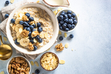 Oatmeal porrige in craft bowl at white background. Top view image with space for text.