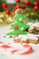 Christmas decoration. Christmas tree branches and homemade decorated Christmas cookies, close up image.	