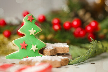 Christmas decoration. Christmas tree branches and homemade decorated Christmas cookies, close up image.	