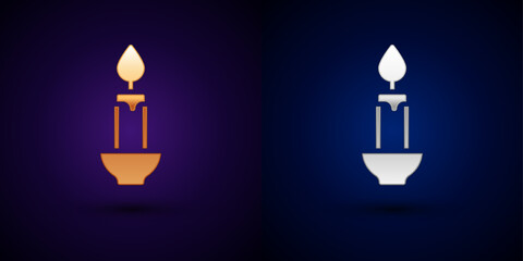 Gold and silver Burning candle icon isolated on black background. Cylindrical candle stick with burning flame. Vector