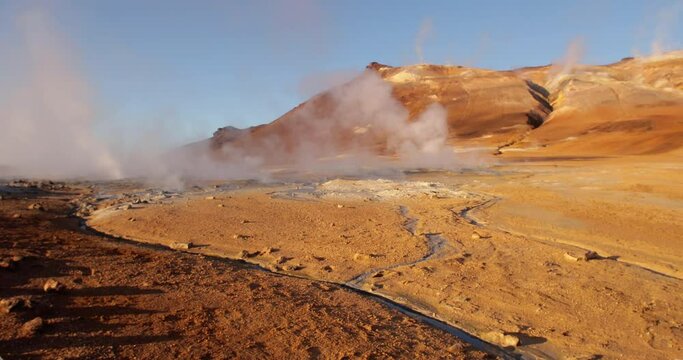 Sulfuric vents puffing white smoke in a mountain in Hverir, Iceland.