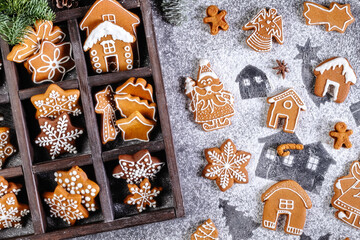 Collection of various gingerbread cookies in a box with fir branches