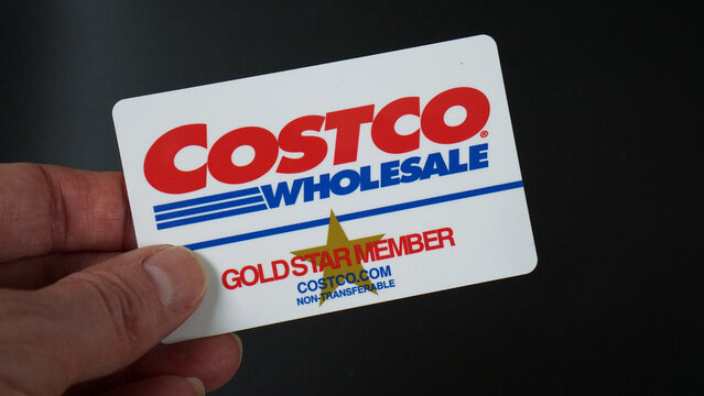 Costco Gold Star Membership card held against a black background.
