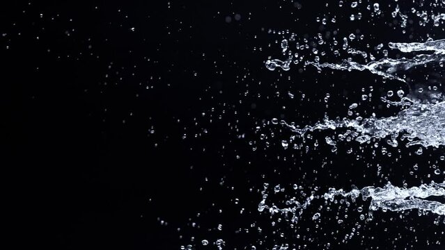 Super Slow Motion Shot of Water Side Splash Isolated on Black Background at 1000fps.