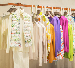 Bright womens clothing on hanger in store. Shopping concept