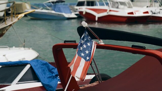 American flag on a yacht in the marina.