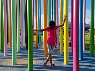 Italy, Milan, city life: child on playground, colors, art design 