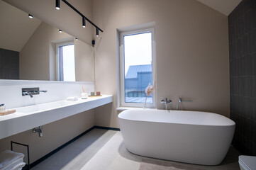 Modern bathroom with clean sanitary ware and LED wall lamps