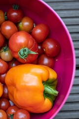 Pile of red ripe tomatoes and peppers.