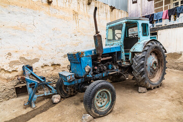 Margib, Sughd Province, Tajikistan. An old blue tractor in a mountain village.