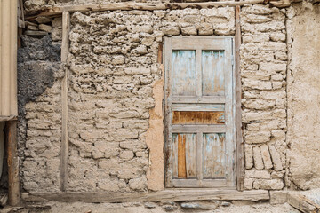 Margib, Sughd Province, Tajikistan. Wooden door in a traditional mud brick home.