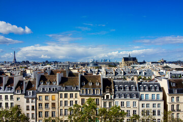 Fototapeta na wymiar France, Paris. Houses facing Beaubourg, Centre Pompidou square, Eiffel tower on the far left