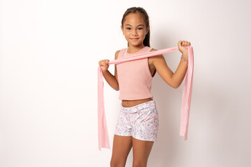 Child girl gymnast demonstrates flexibility twine standing isolated over white background.