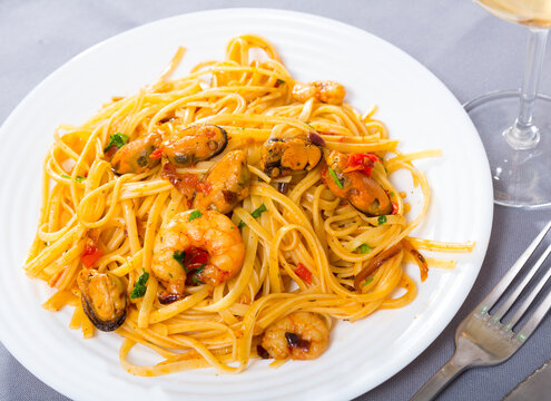 Image of deliciously pasta of shrimps, mussels and fresh greens