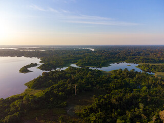 Fototapeta na wymiar Aerial view of Igapó, the Amazon rainforest in Brazil, an incredible green landscape with lots of water and untouched nature at sunset time