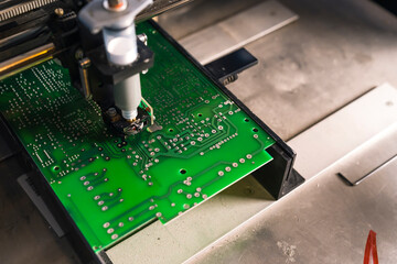 Soldering paste dispenser machine in use. Professional machine glueing electric components onto...