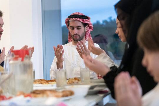 Muslim Family Making Iftar Dua To Break Fasting During Ramadan.