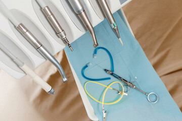 Heart of dentist tools and injection for tooth anesthesia and dental chair tools set close-up on beige background.