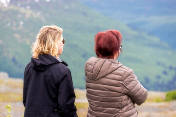 A beautiful mother and daughter enjoy the view at Thompson Pass, on the road to Valdez, Alaska.