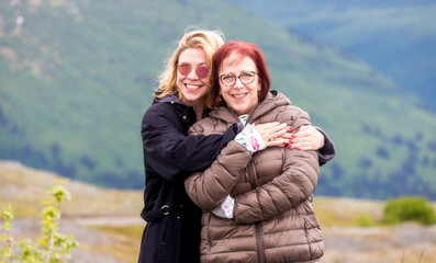 A beautiful mother and daughter enjoy the view at Thompson Pass, on the road to Valdez, Alaska.