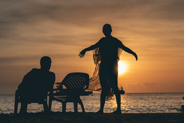 Fototapeta na wymiar Beautiful sunset the silhouette of a man and a woman 