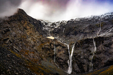 New temporary waterfalls on a rainy day  on the mountains as you drive into Milford Sound