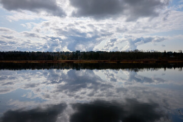 Storm Cloud Break Water Reflection. Cloud reflections on Burbaby Lake, British Columbia, Canada.

