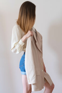 Anonymous female model from behind choosing what to wear 