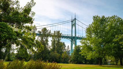 Autumn landscape of St. John's Bridge over Willamette River. St. John's Bridge over Willamette River, viewed from Cathedral City Park in Portland, Oregon State.