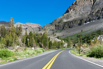 Scenic Highway 108 road running through Sierra Nevada mountain scenery on a sunny summer day in summer near Sonora Pass