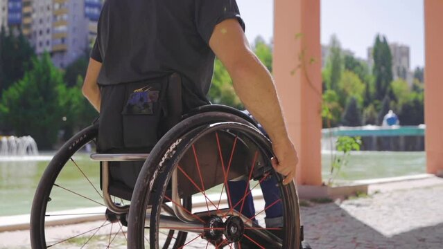 Man sitting in wheelchair in slow motion.
Disabled young man using wheelchair in slow motion.
