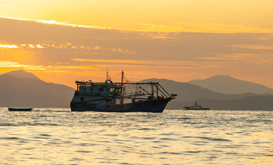 old fishing ship on the sea.scene with a boat in sunset.