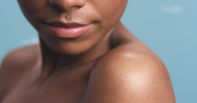 Body natural skincare, black woman beauty and blue background with bare shoulder. Smooth dark skin, nude soft arm luxury spa wellness, clean and healthy model cosmetic product ad closeup in studio