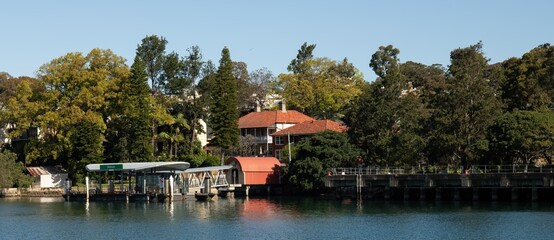 View of Balmain ferry wharf with arched roofed, heritage-listed community library building in...