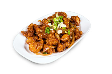 Chinese and oriental dish Chili Chicken  garnished with green onions on a white plate isolated on white