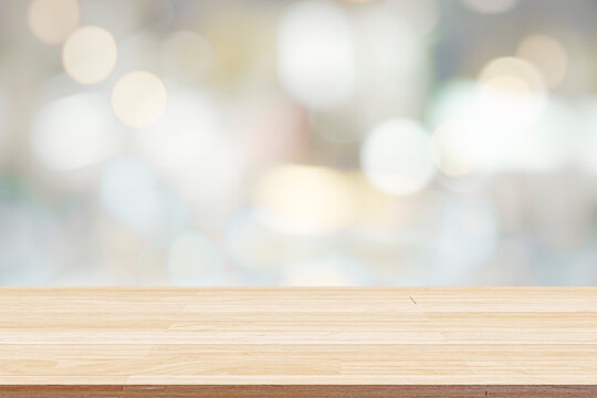 Empty wooden table for present product on bokeh blur background image.