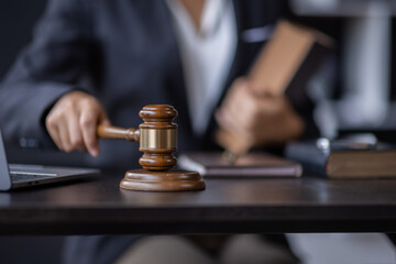 Attractive lawyer in office Business woman and lawyers discussing contract papers with brass scale on wooden desk in workplace. Law, legal services, advice, Justice and real estate concept.