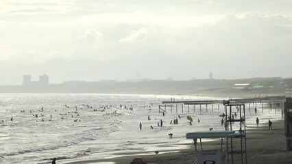 FUJISAWA, KANAGAWA, JAPAN - AUGUST 2022 : View of Enoshima beach (sea) at Shonan area in sunset. Romantic, moody sky in dusk. Japanese hot summer holiday (vacation) season concept video.